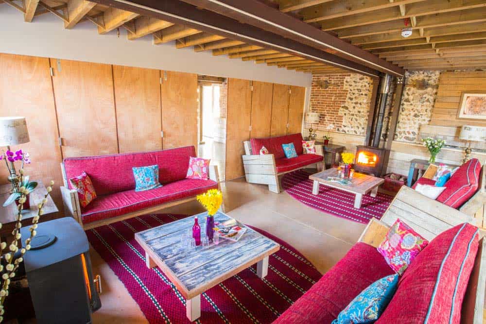 living area red sofas wood burner norfolk yoga retreat
