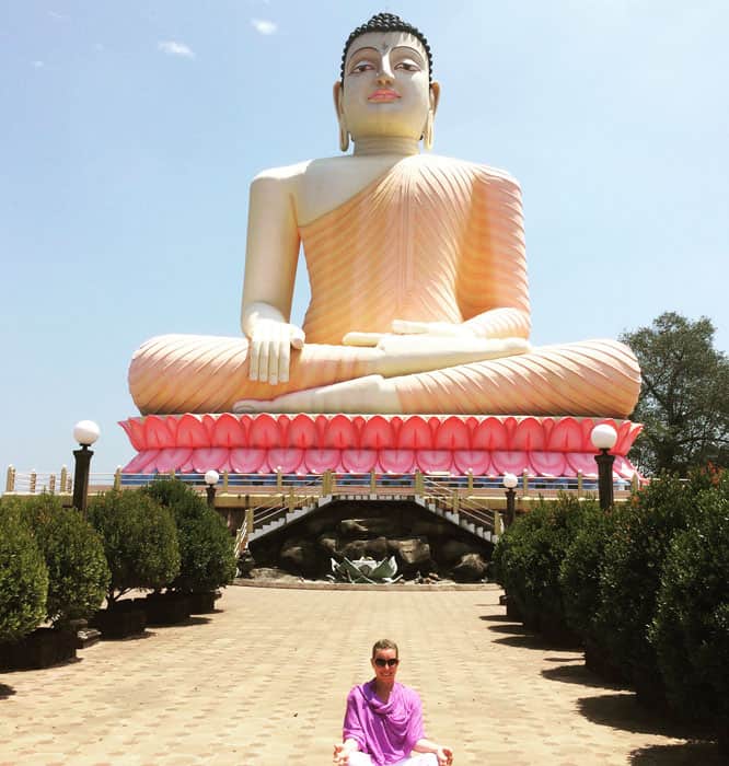 Big Buddha statue with guest sitting under
