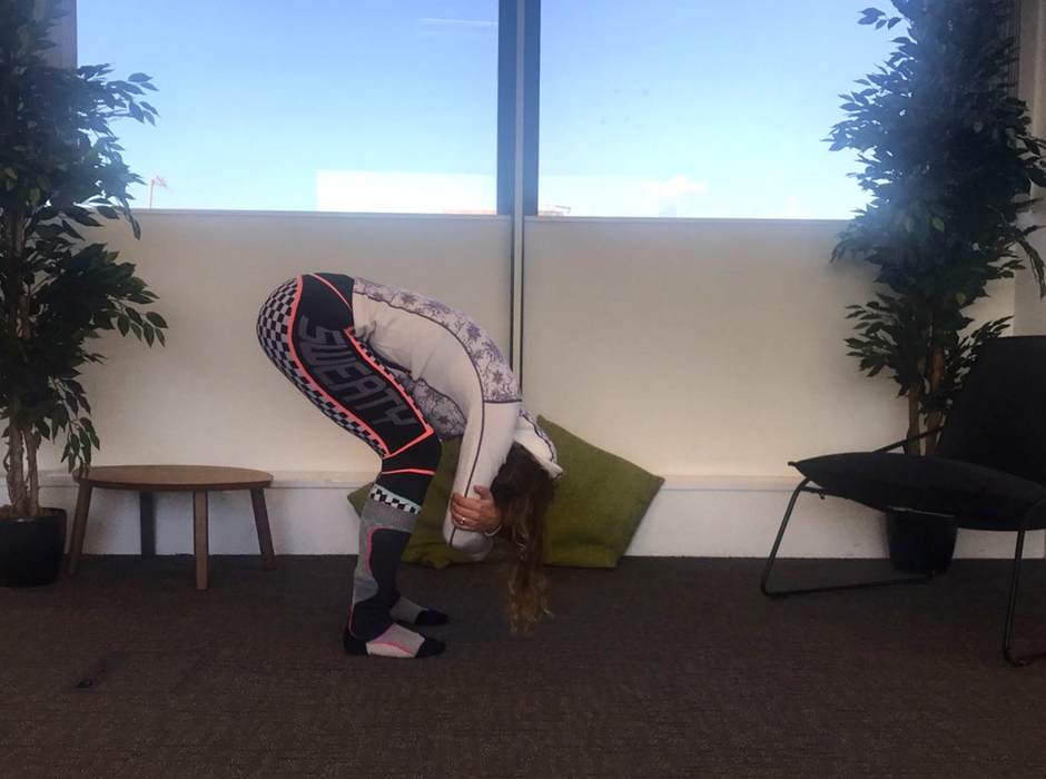 person doing forward bend with knees bent