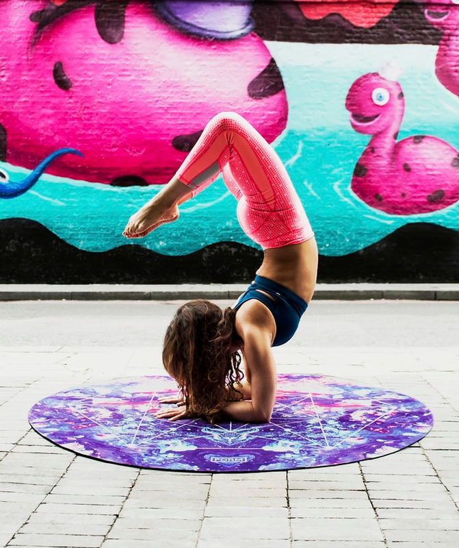 girl doing scorpion yoga pose on mat