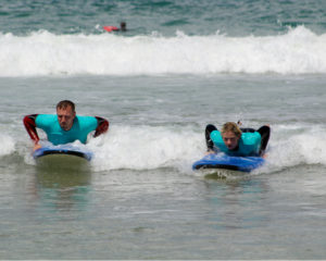 two guests surfing cornwall yoga retreat