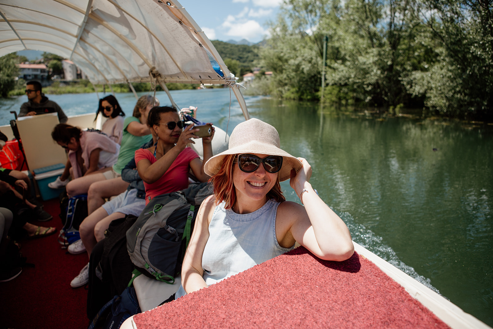 lady in hat and other people on boat sunshine - yoga holiday montenegro