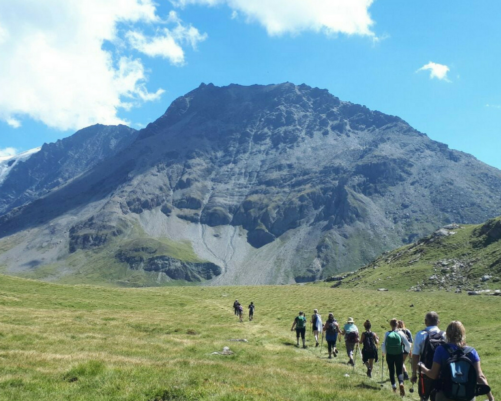 Line of walkers heading towards mountains