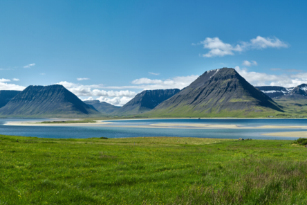 Iceland summer landscape mountains, lake, houses