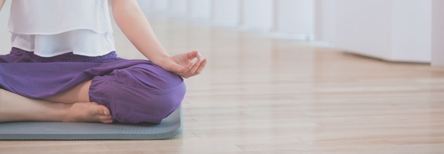 woman legs and arms sat in meditation on yoga mat