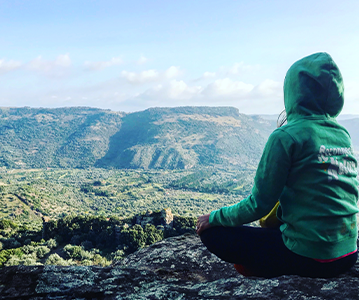 person meditating mountain views