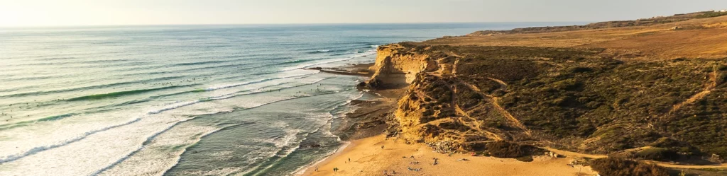 coastal cliffs in portugal with rolling waves