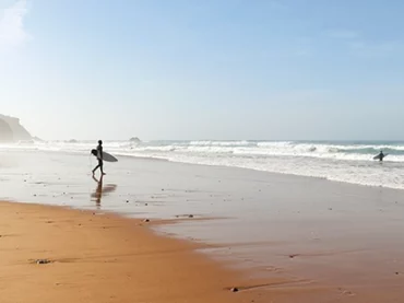 someone about to go surfing in portugal