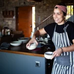 chef bringing out bowls to serve food