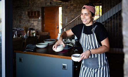 chef bringing out bowls to serve food