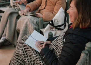 lady writing down her new year intentions during yoga retreat workshop